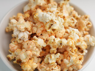 Popcorns on white bowl, isolated on white