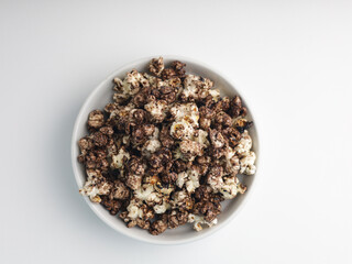 Popcorns on white bowl, isolated on white