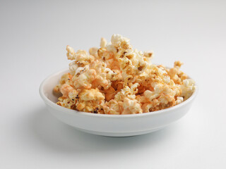 Popcorns on white bowl, isolated on white