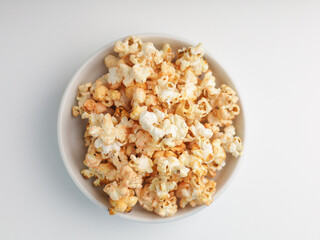 Popcorns on white bowl, isolated on white
