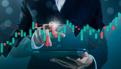 Business trader is showing a growing and stock market graph and investment and currency exchange, Planning and strategy concept.