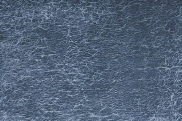 Midnight blue hues dominate a textured wall with a complex network of white thread-like lines creating an intricate web pattern resembling a sky filled with a multitude of lightening bolts.