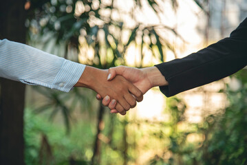 Team Business Partners shaking hands together to Greeting Start up small business in meeting room....