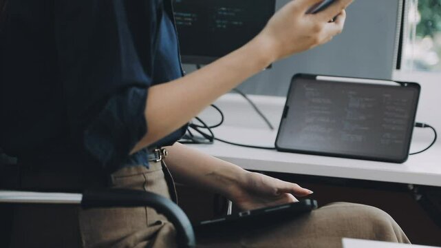Two asian team working development of programming and encryption technology website design programmers on desk in office