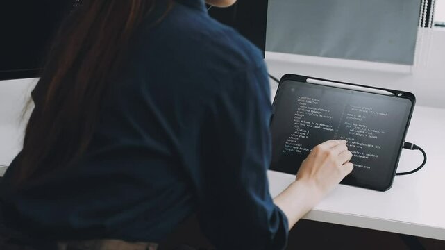 Two asian team working development of programming and encryption technology website design programmers on desk in office