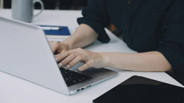 Two asian team working development of programming and encryption technology website design programmers on desk in office