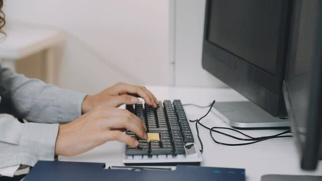 Two asian team working development of programming and encryption technology website design programmers on desk in office
