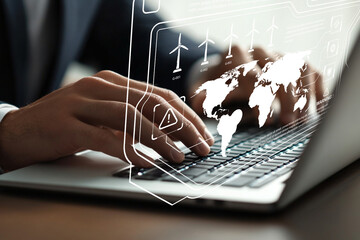 Business Professional Analyzing Data on Laptop with Digital Interface Showing Global Connection and Renewable Energy Concepts