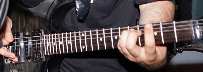 guitarist playing an electric guitar
