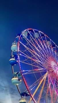 Ferris wheel at night with Colorful Lights at Fair
