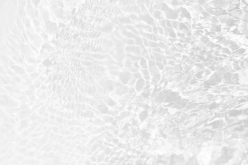 White water with ripples on the surface. Defocus blurred transparent white colored clear calm water surface texture with splashes and bubbles. Water waves with shining pattern texture background.