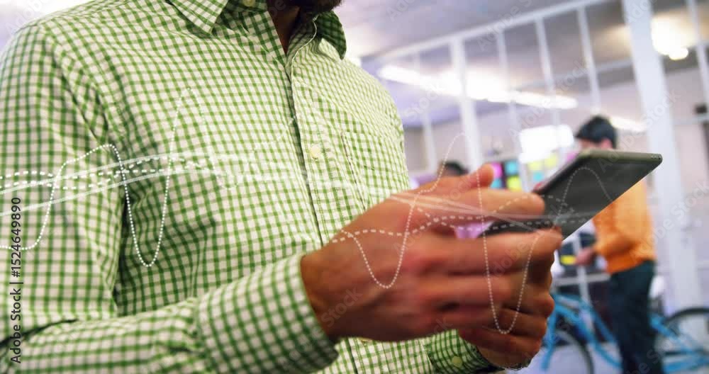 Aufkleber mid adult male tapping and swiping tablet in tech generating waveforms while reviewing data nodding