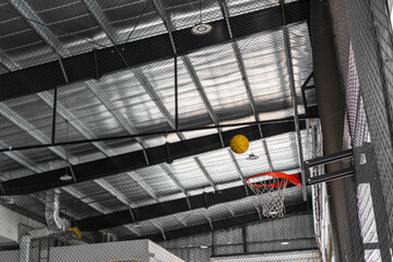 old yellow ball shoot is about to go into the red basketball hoop to success for training and sports exercise in stadium school or indoor basketball court to win and goal score in match competition