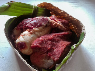 Pile of Raw Meat on Banana Leaf Isolated