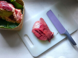 Thick cut of red beef meat on white