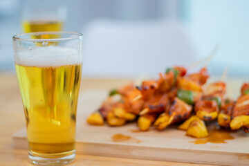 A group of young people gather and celebrate a simple beer party to share a special meal filled with laughter, conversation and friendship at an intimate dining celebration.