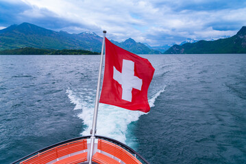 Swiss flag at the back of a boat on Thun lake at Interlaken, Switzerland