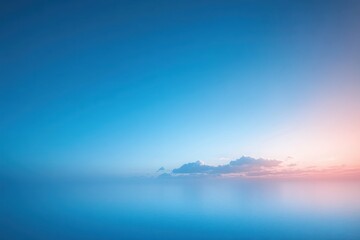 Obraz premium Calm blue ocean meeting a clear sky with soft clouds and gentle sunrise or sunset light creating a peaceful and serene atmosphere