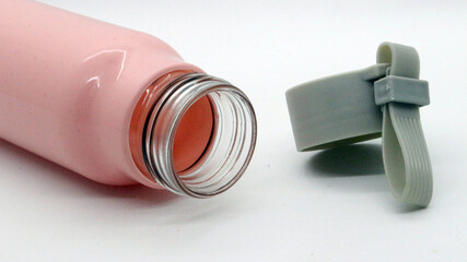 Pink colored bottle on white background