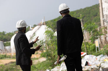 Two businessman or management team audit environment and rubbish around factory, Industrial and environment. NGO staff audit environment issue from industrial estate