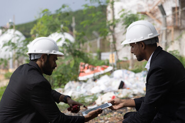 Two businessman or management team audit environment and rubbish around factory, Industrial and environment. NGO staff audit environment issue from industrial estate