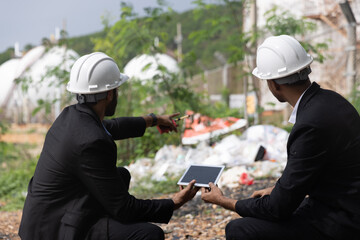 Two management with formal suit and safety hardhat check and audit environment surround factory 
