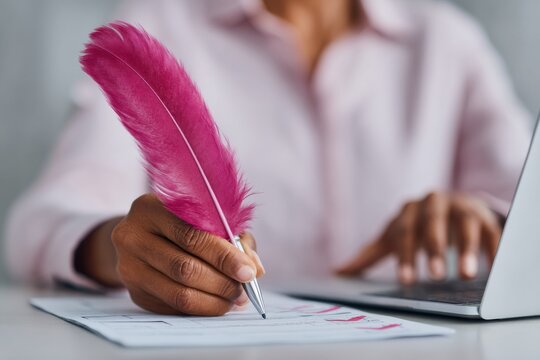 Modern business professional marking digital checklist with vibrant feather pen on laptop for workflow optimization and project management in corporate setting