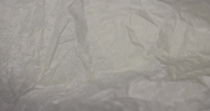 crumpled paper after prolonged use, thin paper made of cellulose as a packaging material for clothing, close up