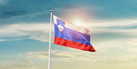 Slovenia flag waving in beautiful sky with mast. A proud moment flag waving with sunlight.