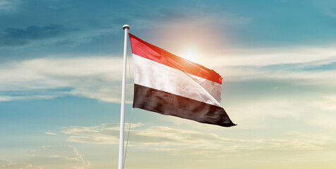 Yemen flag waving in beautiful sky with mast. A proud moment flag waving with sunlight.