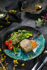 Filet mignon steak in edible gold with smashed cucumbers and tomatoes, dramatic lighting, modern composition