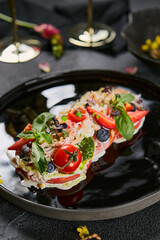 Crab bruschetta with fresh microgreens on glossy black plate, moody lighting, vibrant color composition