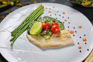 Halibut fillet with spinach, asparagus, and cherry tomatoes, bright natural light, minimalistic composition