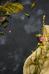 Mimosa and fresh floral composition, airy top view with moody lighting, contrasting colors,...