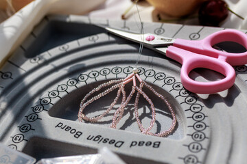 Fototapeta premium Hobby concept.Tablet for making jewelry with the work process.Top view.