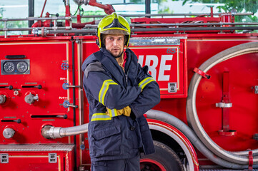 Firefighters in fire fighter safety suit stand in front of Fire truck in emergency situation.. - Safety Firefighter and industrial concept.