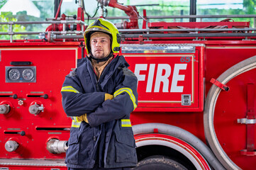 Firefighters in fire fighter safety suit stand in front of Fire truck in emergency situation.. - Safety Firefighter and industrial concept.