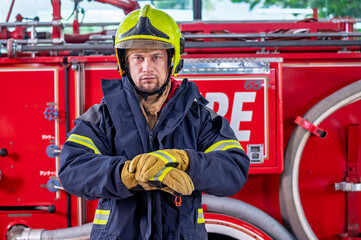 Firefighters in fire fighter safety suit stand in front of Fire truck in emergency situation.. - Safety Firefighter and industrial concept.