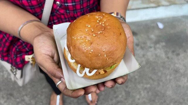 Large sized burger filled with fried chicken