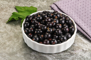 Ripe black currant in the bowl