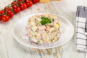 Russian traditional Olivier salad with sausages