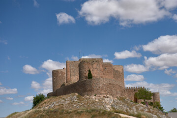 Castle of Consuegra in Toledo on a hill under a blue sky