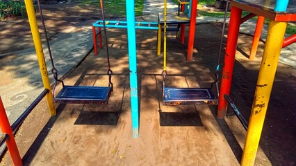 Vivid playground swings for children, suitable for park or school recreational areas, enhancing outdoor activity spaces.