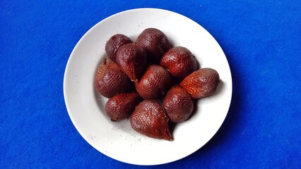Fresh snakefruits on White Plate