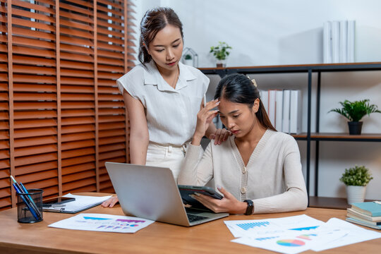 Efficient marketing planning is essential for cosmetic packaging success as two professionals analyze data on tablet in modern office setting. Their collaboration highlights strategic insights