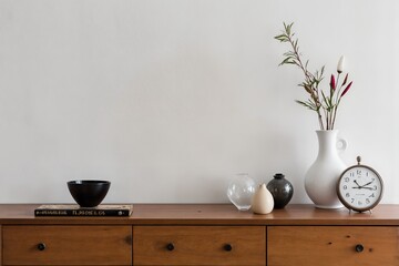 A wooden dresser with a clock on top of it.