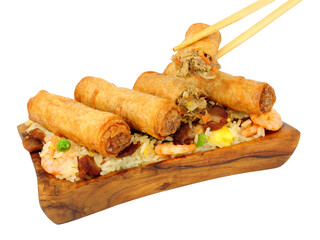 Chinese duck meat and vegetable spring rolls with special fried rice in a olive wood serving dish isolated on a white background