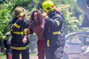 Firefighter emergency rescue help young woman from dangerous smoke and burning accident. - Safety and rescue operation comcept