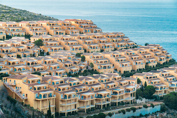 Obraz premium Residential complex with terraced houses in the mountains, residential urban planning concept.