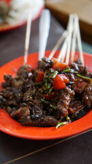 Satay (sate) is a traditional Southeast Asian dish, commonly found in Indonesia and served with...